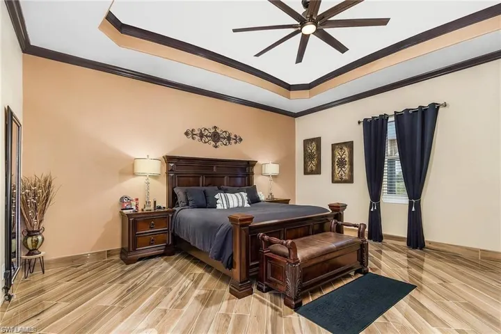 Bedroom with crown molding and ceiling fan