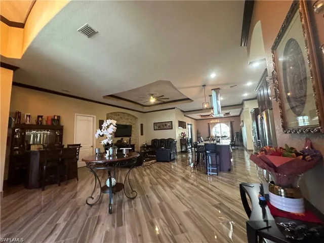 Dining room with wood-type flooring, ornamental molding, and ceiling fan