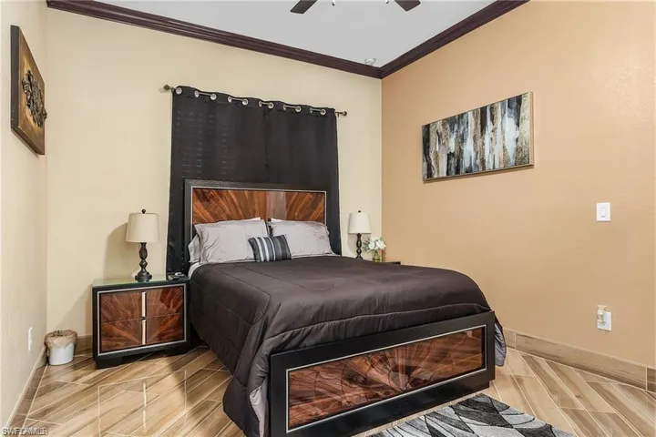 Bedroom featuring ornamental molding and ceiling fan