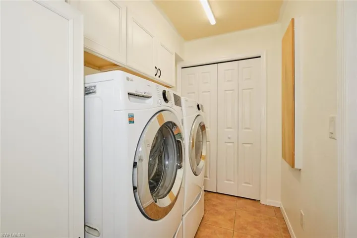 Expansive laundry room with extra cabinets and pantry.
