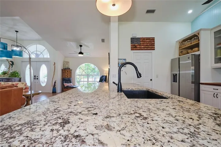 Gorgeous granite countertop on the island with farmhouse sink.