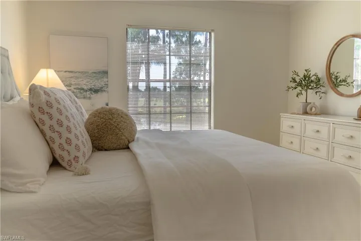 The property features a spacious room with light-colored walls and a window with horizontal blinds, providing natural light