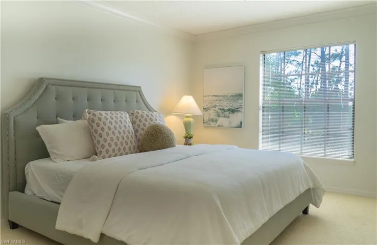 This room features a window with blinds, light-colored walls, and carpeting