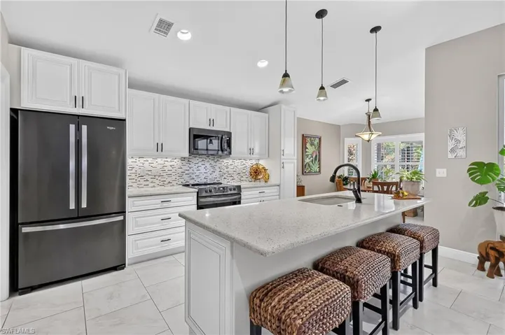 Remodeled Kitchen with quartz countertops and breakfast bar.