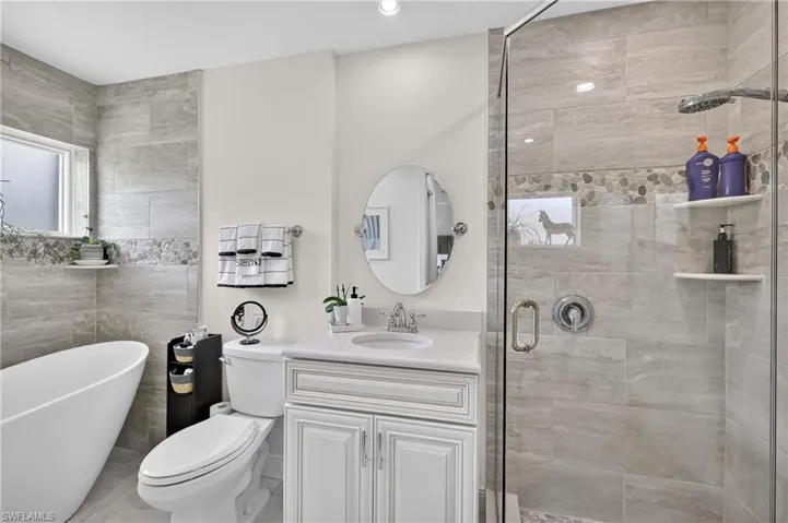 Remodeled Primary Bathroom with soaking tub, separate shower, and quartz vanity top.