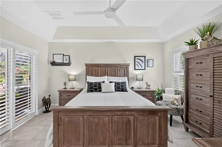 Primary Bedroom with Sliding glass doors to the pool area.