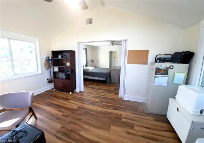 Office with beam ceiling, ceiling fan, high vaulted ceiling, and dark hardwood / wood-style floors