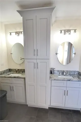 Bathroom with tile patterned flooring and vanity