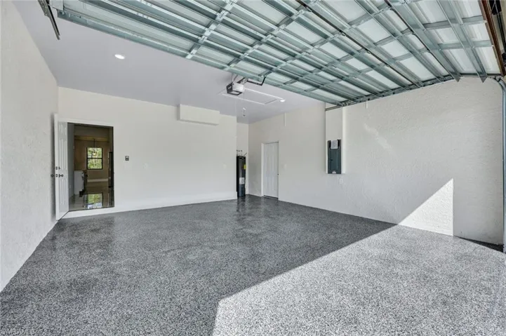 Garage with electric panel and a garage door opener