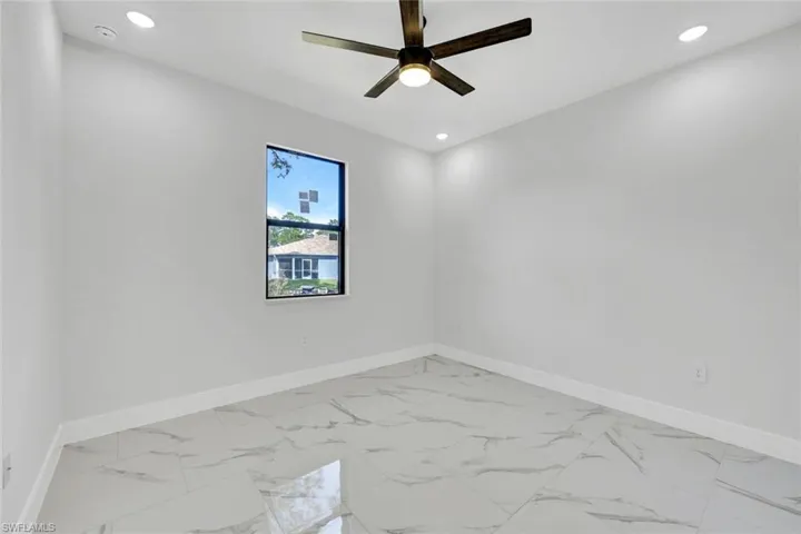 Spare room featuring ceiling fan, recessed lighting, and baseboards
