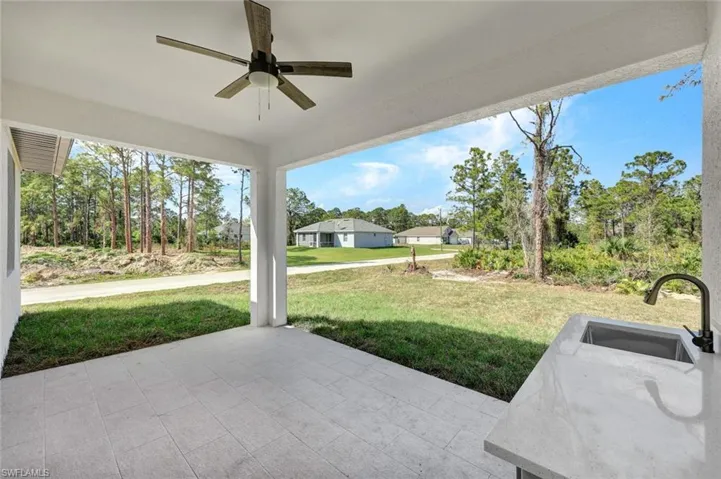 View of patio / terrace featuring ceiling fan and a sink