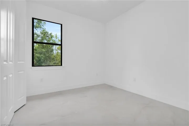 Empty room with baseboards and light marble finish floors