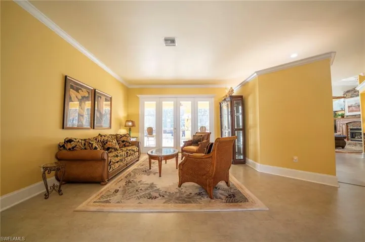 Living room featuring ornamental molding and french doors
