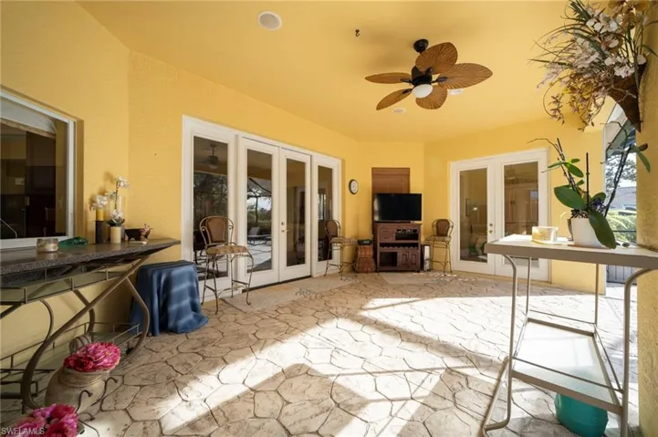 View of patio / terrace with french doors, ceiling fan, and an outdoor kitchen