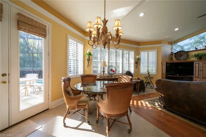 Dining space with light hardwood / wood-style flooring and a chandelier