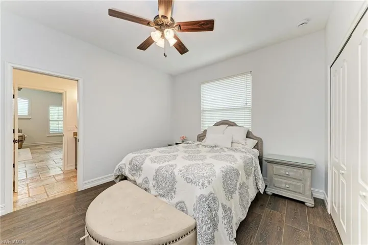 Bedroom featuring a closet, a ceiling fan, and dark wood finished floors