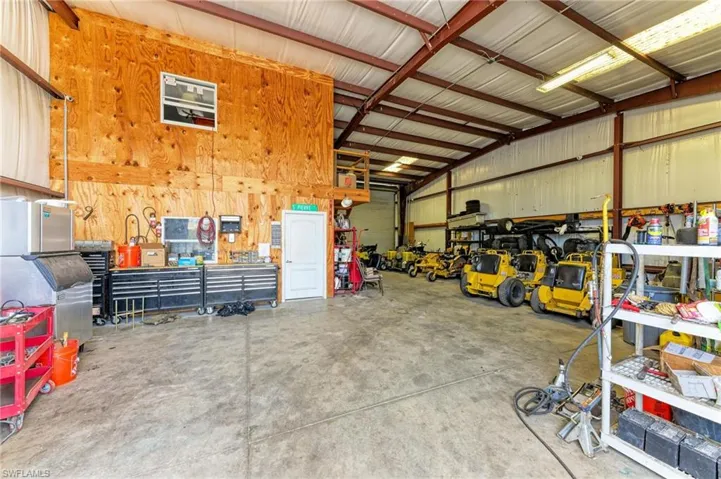 Garage featuring a workshop area and metal wall
