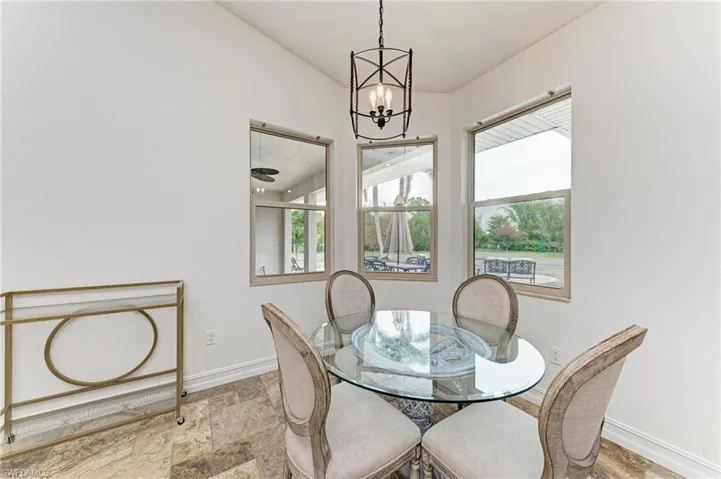 Dining area with stone finish flooring, suspended lighting, and healthy amount of natural light