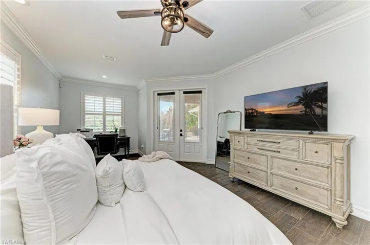 Bedroom with dark wood finished floors, access to outside, a ceiling fan, ornamental molding, and recessed lighting