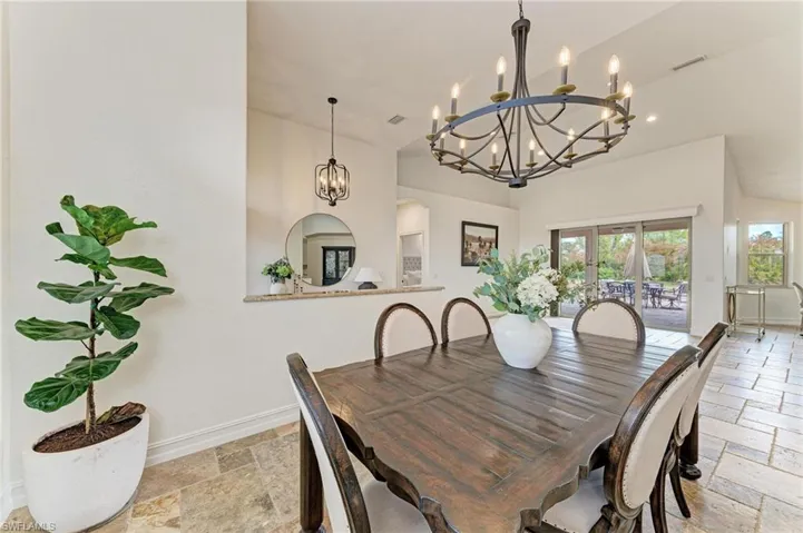 Dining space with stone tile floors and hanging lights