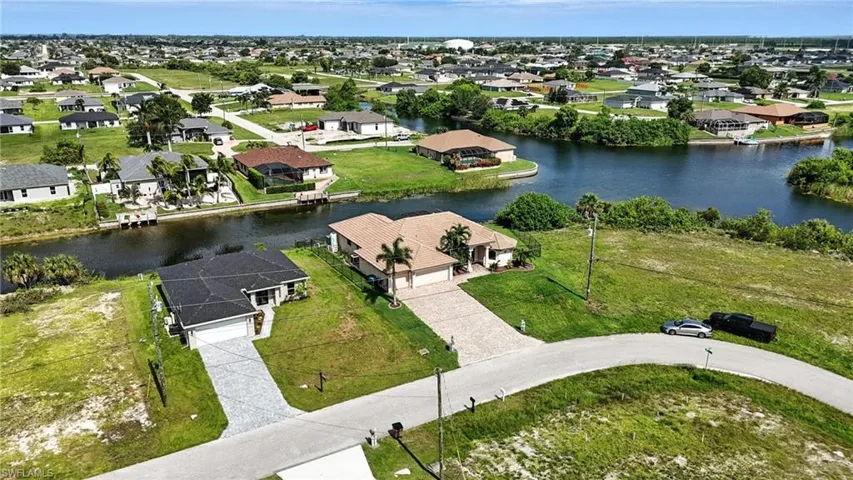 Aerial perspective of suburban area with a nearby body of water