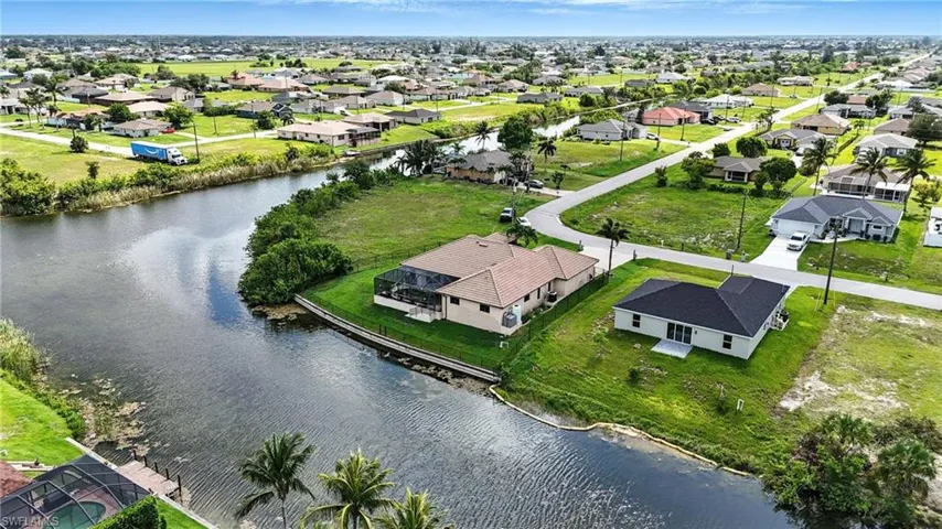 Aerial view of residential area featuring a nearby body of water