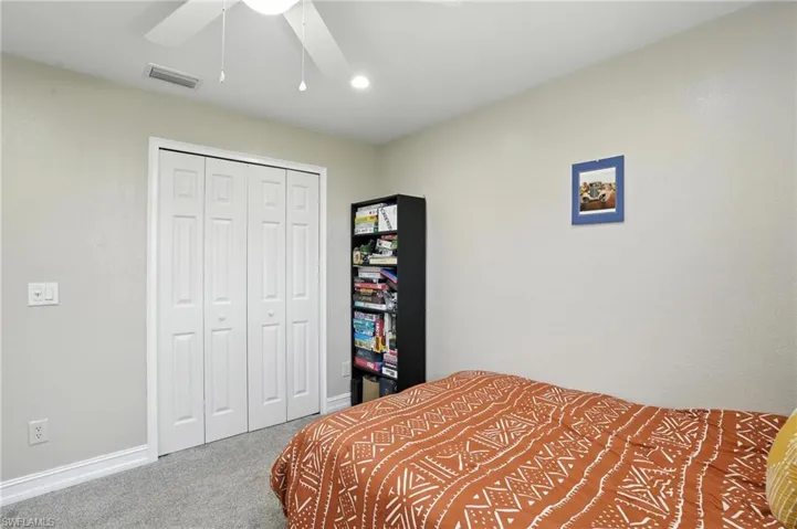 Bedroom featuring carpet floors, a closet, and ceiling fan