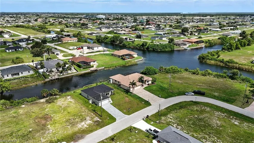 Aerial perspective of suburban area with a large body of water