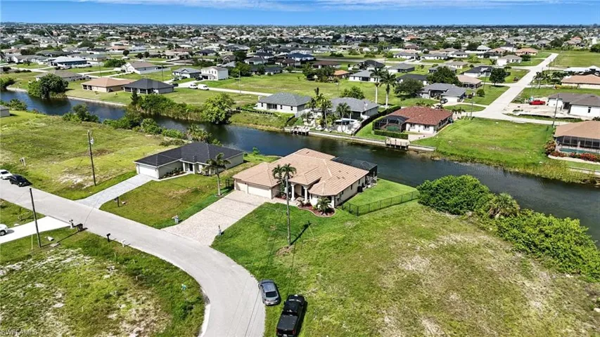 Aerial perspective of suburban area featuring a large body of water
