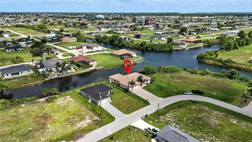 Aerial view of residential area featuring a large body of water
