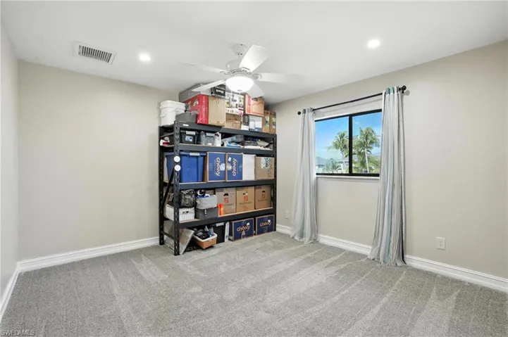 Bedroom with carpet floors, ceiling fan, and recessed lighting