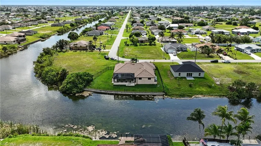 Aerial view of residential area featuring a large body of water