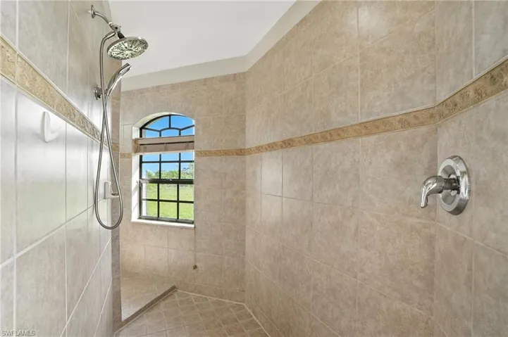 Full bath featuring tiled shower