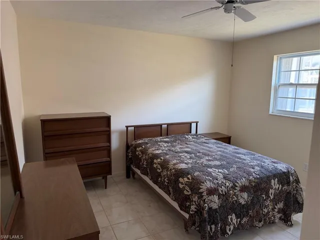 Bedroom with ceiling fan and baseboards