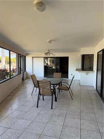 Sunroom / solarium featuring outdoor dining space and ceiling fan