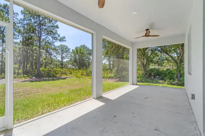 Unfurnished sunroom with ceiling fan and plenty of natural light