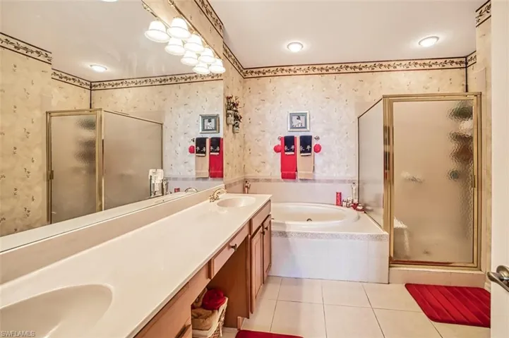 Bathroom featuring vanity, separate shower and tub, and tile patterned floors