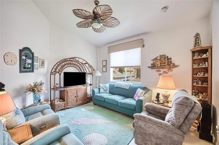 Living room featuring lofted ceiling and ceiling fan