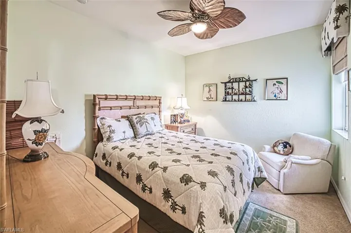 Carpeted bedroom featuring ceiling fan
