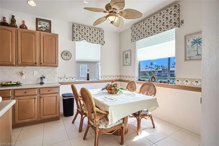 Tiled dining room featuring ceiling fan