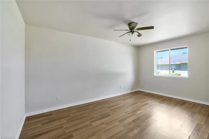 Spare room featuring ceiling fan and wood-style flooring