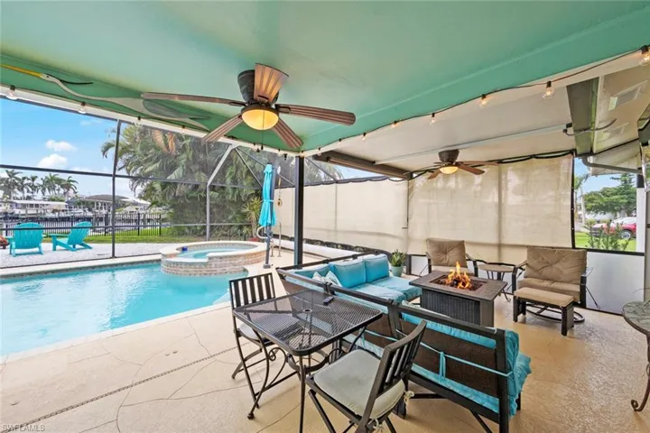 View of swimming pool with an outdoor living space with a fire pit, a patio area, and an in ground hot tub