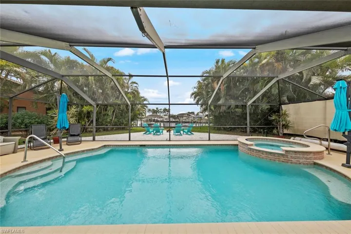 View of pool with an in ground hot tub, a lanai, and a patio