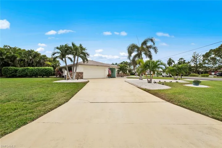 View of front of house featuring a garage and a front yard
