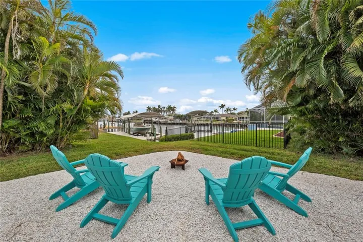 View of patio with a water view and a fire pit