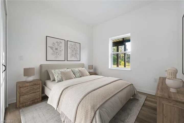 Bedroom featuring wood finished floors and baseboards