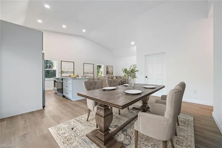 Dining space with recessed lighting, light wood-style flooring, and high vaulted ceiling