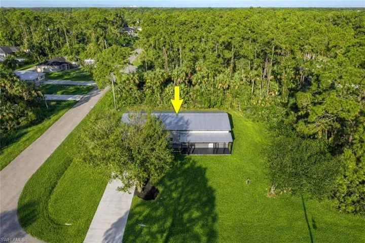 View of subject property with a forest