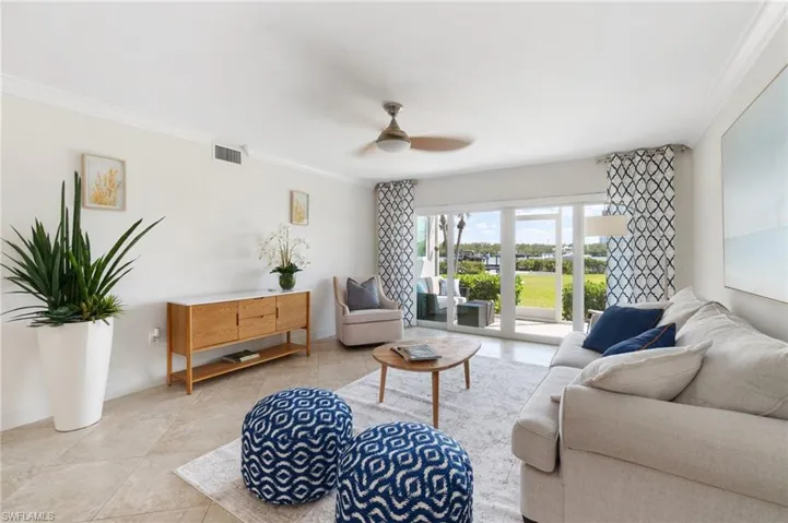 Open concept living-dining kitchen with screened lanai walk out to lawn, pool and deeded boat dock