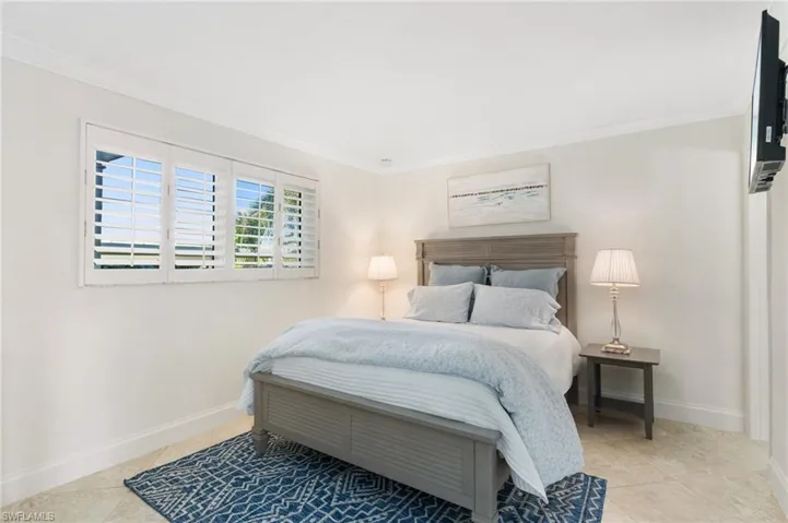 guest bedroom with walk in closet and en suite full bath